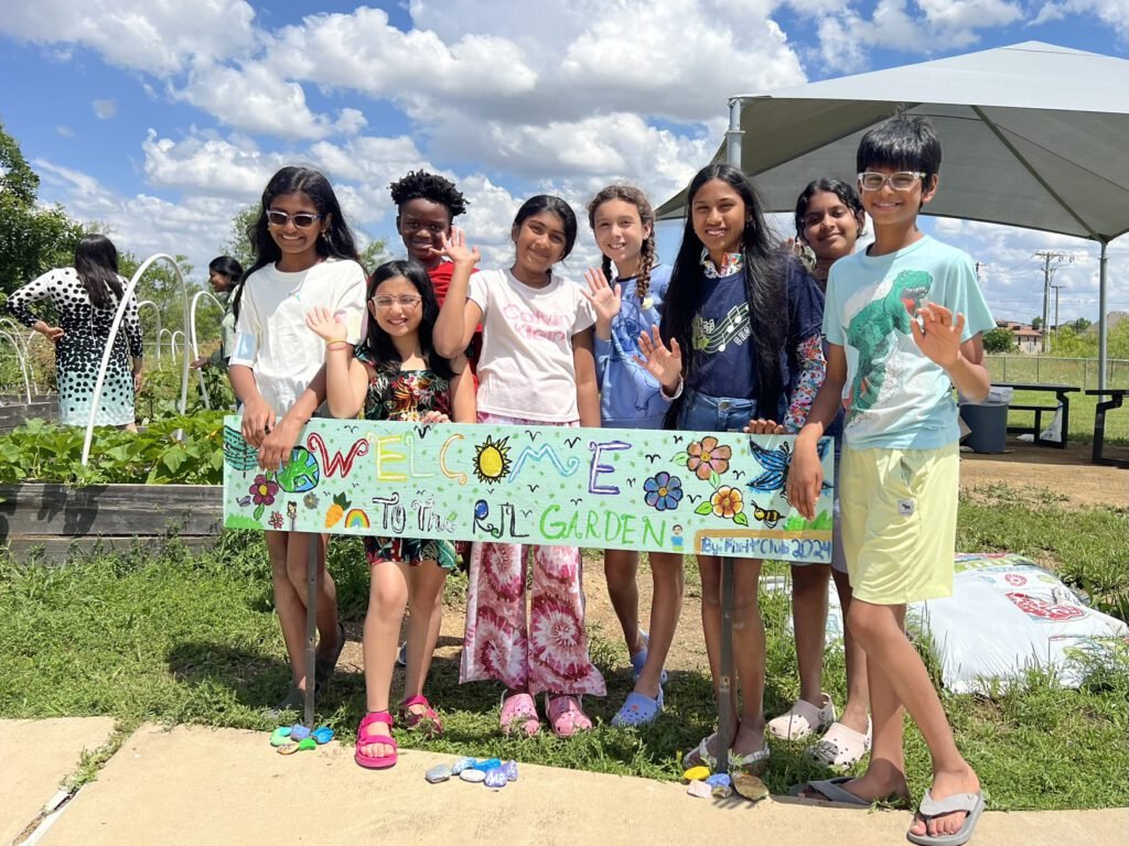 RJL Fix-it Club members and the Garden Welcome Sign they created.